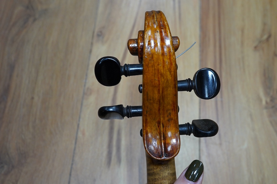 A cased early 20th century European violin, with label reading ‘Antonius Stradivarius Cremonenfis’, body length 36cm, with P&H London bow. Condition - good